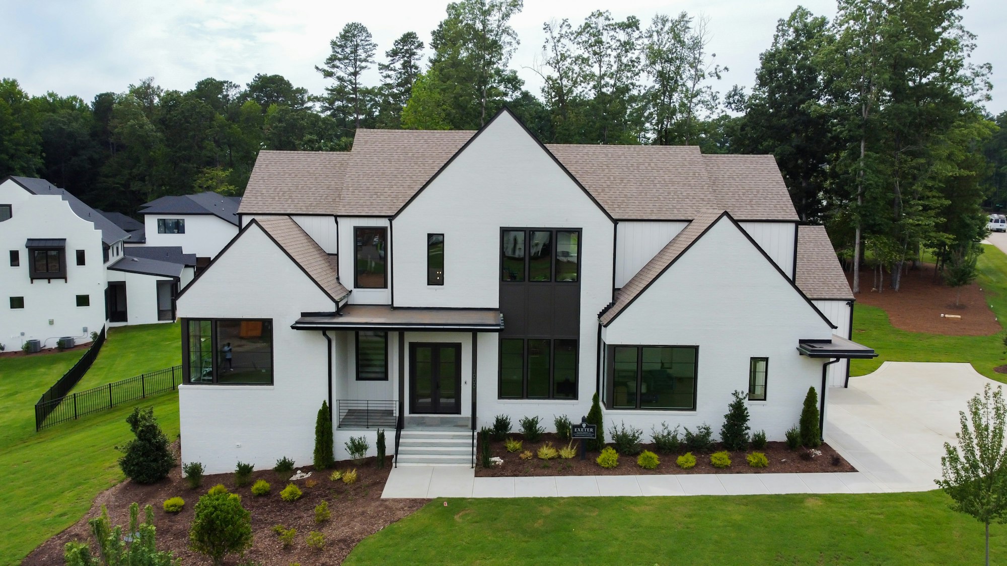 Large white farmhouse with manicured lawn