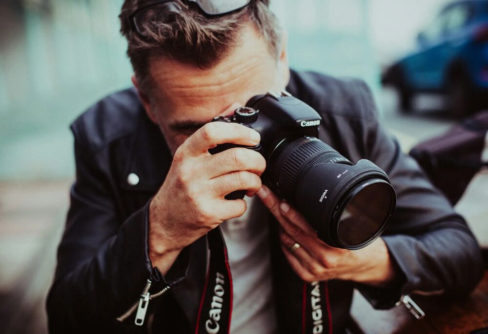 Photographer composing an interior real estate shot with professional camera equipment